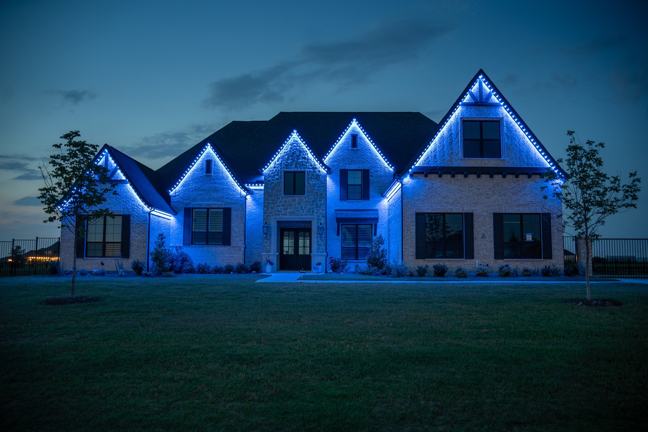 Eaves, gables and dormers traced — real permanent lighting installation